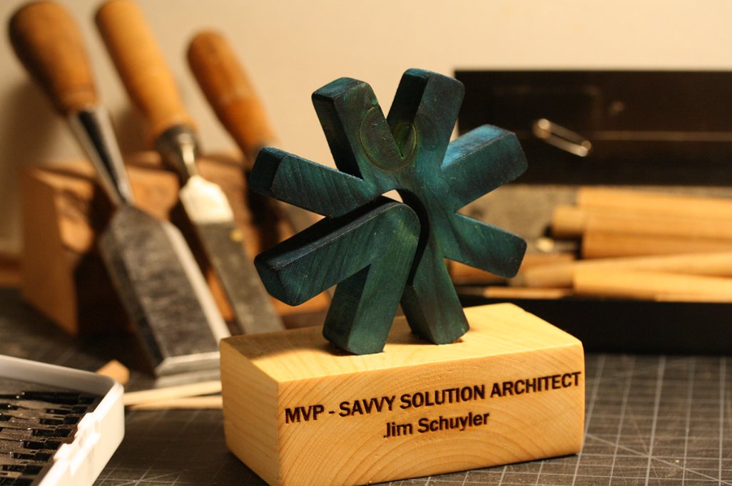 Hand-carved green asterisk MVP award mounted on a maple base