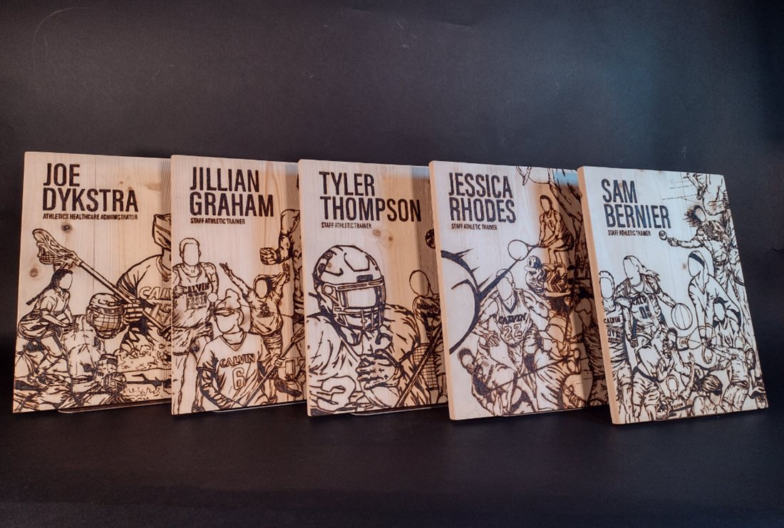 Row of engraved wood athletic award plaques