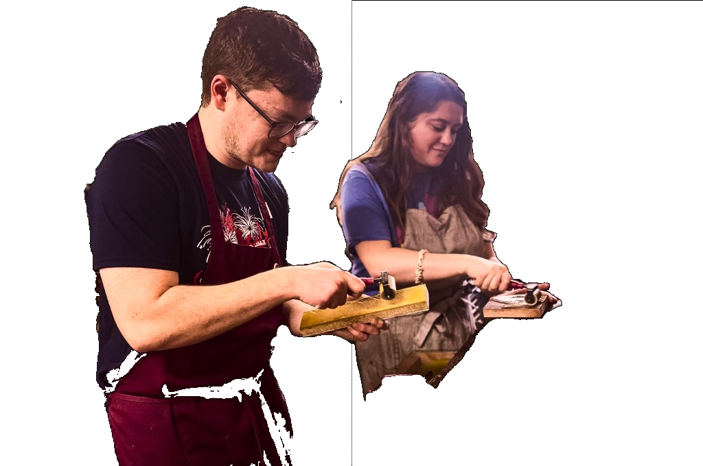 Two printers inking and pulling a letterpress print together during a hands-on Legwork Press workshop